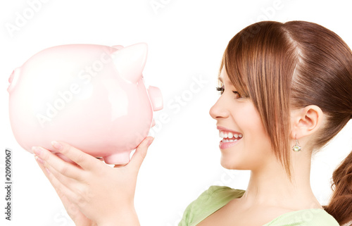 lovely teenage girl with piggy bank