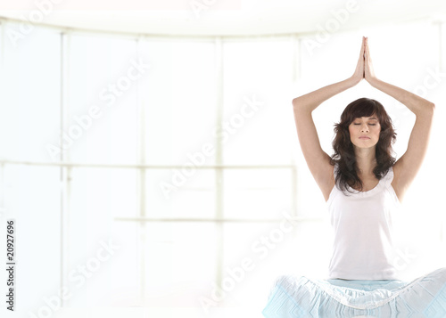 Young fit brunette meditating