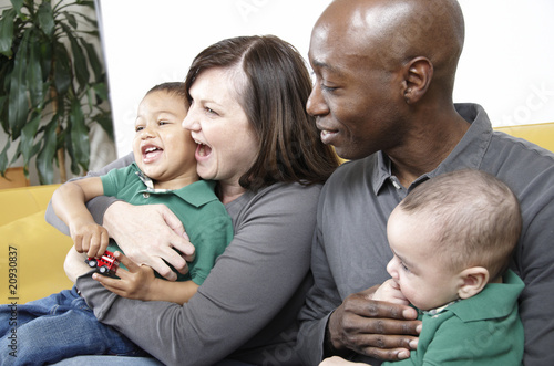 Multi racial family seated together