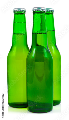 Three green beer bottles in a white background