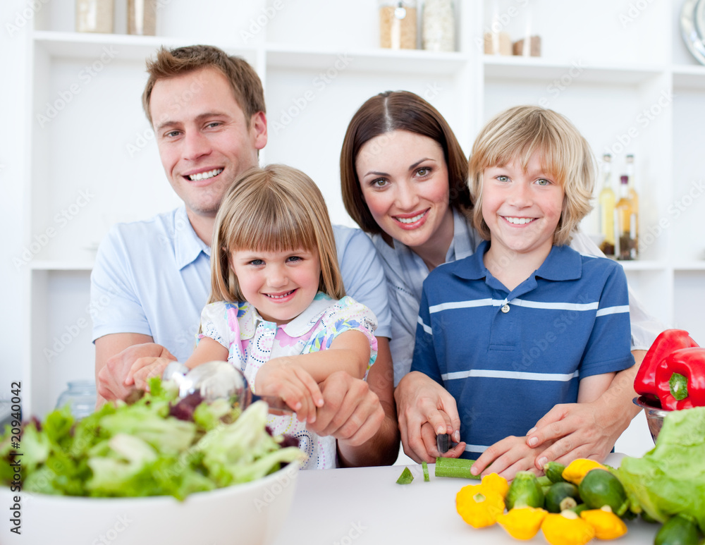Cheerful young family cooking together Cheerful young family cooking together