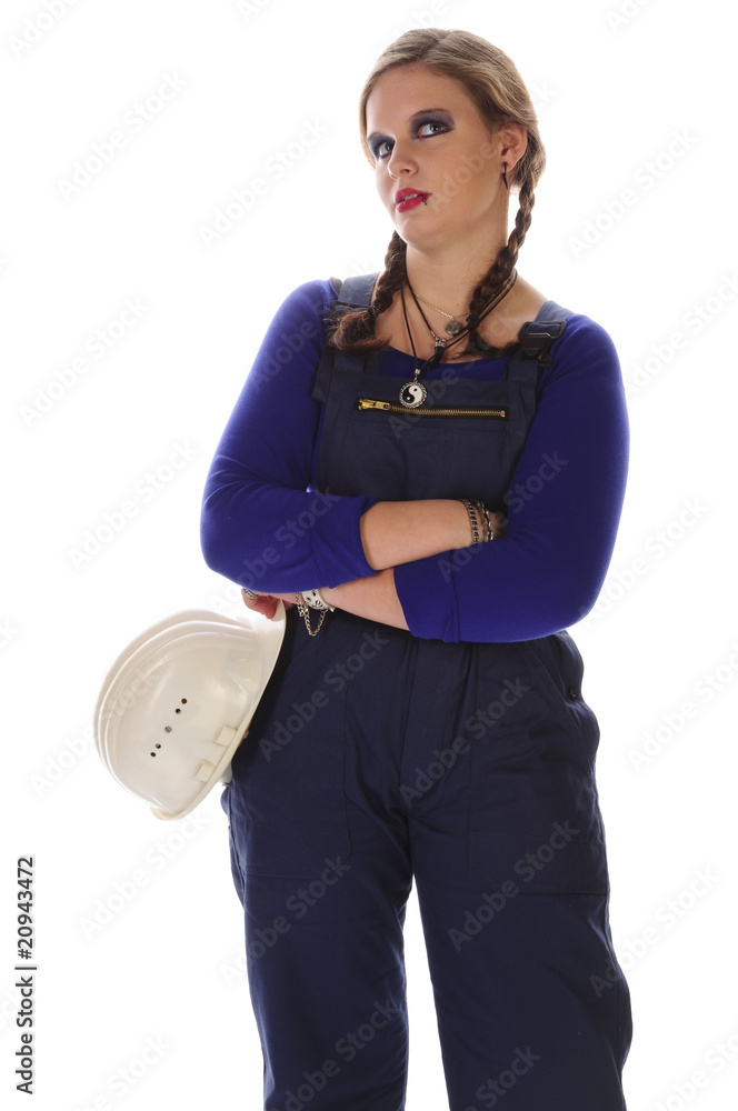 Mädchen im Blaumann mit Bauhelm, genervt Mädchen im Blaumann mit Bauhelm, genervt