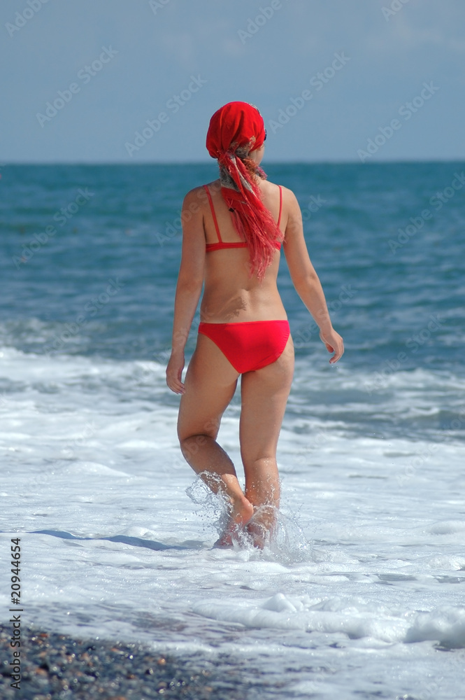 Woman goes on beach Woman goes on beach