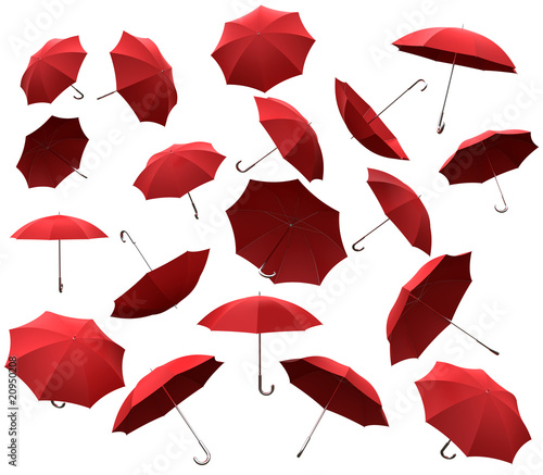 Many redl flying umbrellas on white background photo