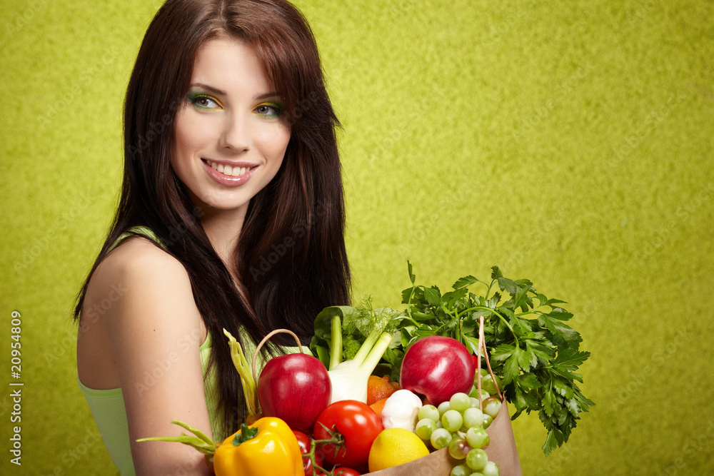 Portrait of a girl holding in hands full of different fruits and Portrait of a girl holding in hands full of different fruits and