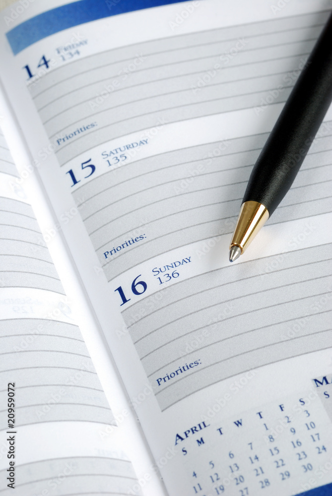 Write down the appointment in a day planner Write down the appointment in a day planner