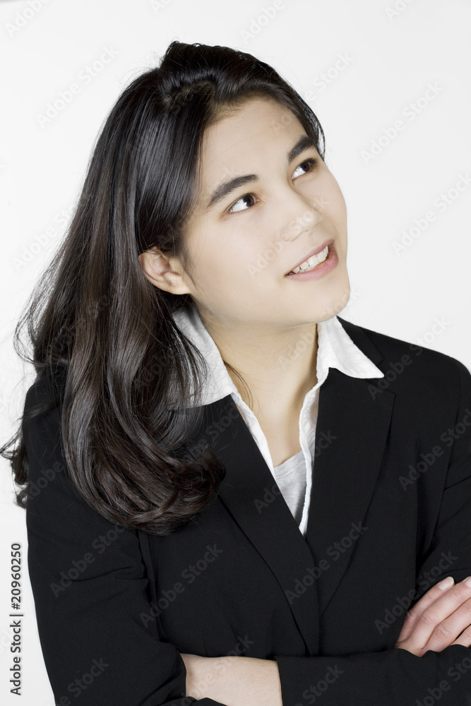 Teenage or young woman in business suit thinking Teenage or young woman in business suit thinking