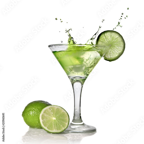 Green alchohol cocktail with splash and green lime