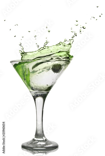 Green alcohol cocktail with splash isolated on white