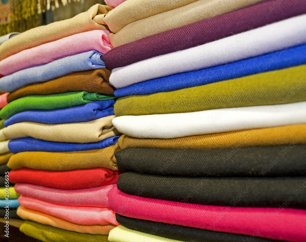 Fabrics stacked on a market stall Fabrics stacked on a market stall