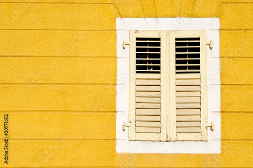 Yellow wall an and wooden window