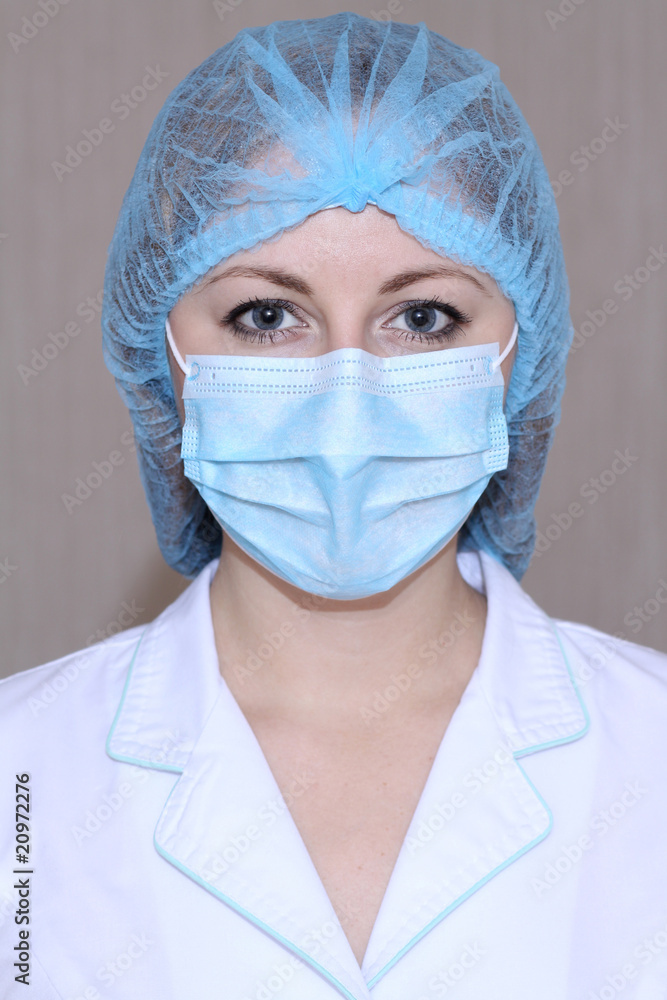 Closeup portrait of a young doctor wearing a mask Closeup portrait of a young doctor wearing a mask