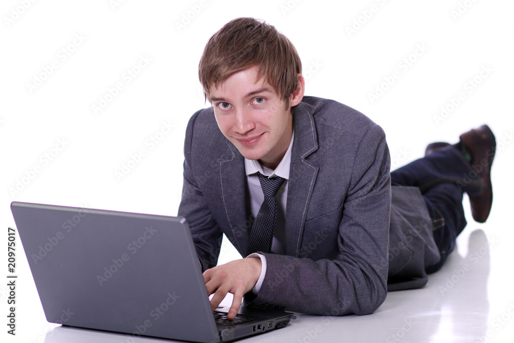 Handsome laptop man laying on the floor Handsome laptop man laying on the floor