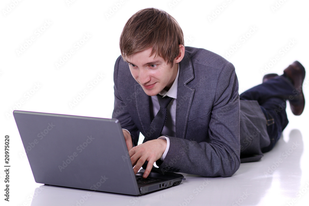 Handsome laptop man laying on the floor Handsome laptop man laying on the floor