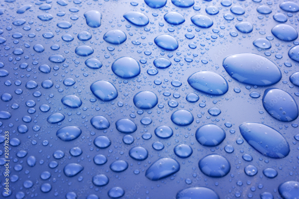 Blue water drops background with big and small drops Blue water drops background with big and small drops