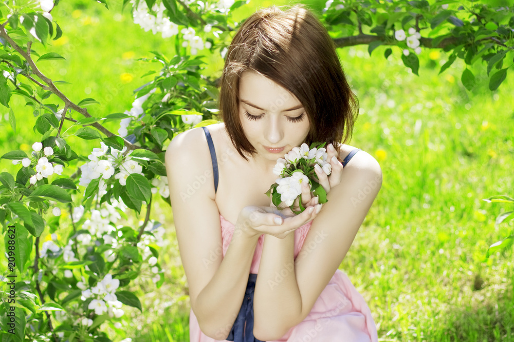 Girl on a background of flowering trees Girl on a background of flowering trees