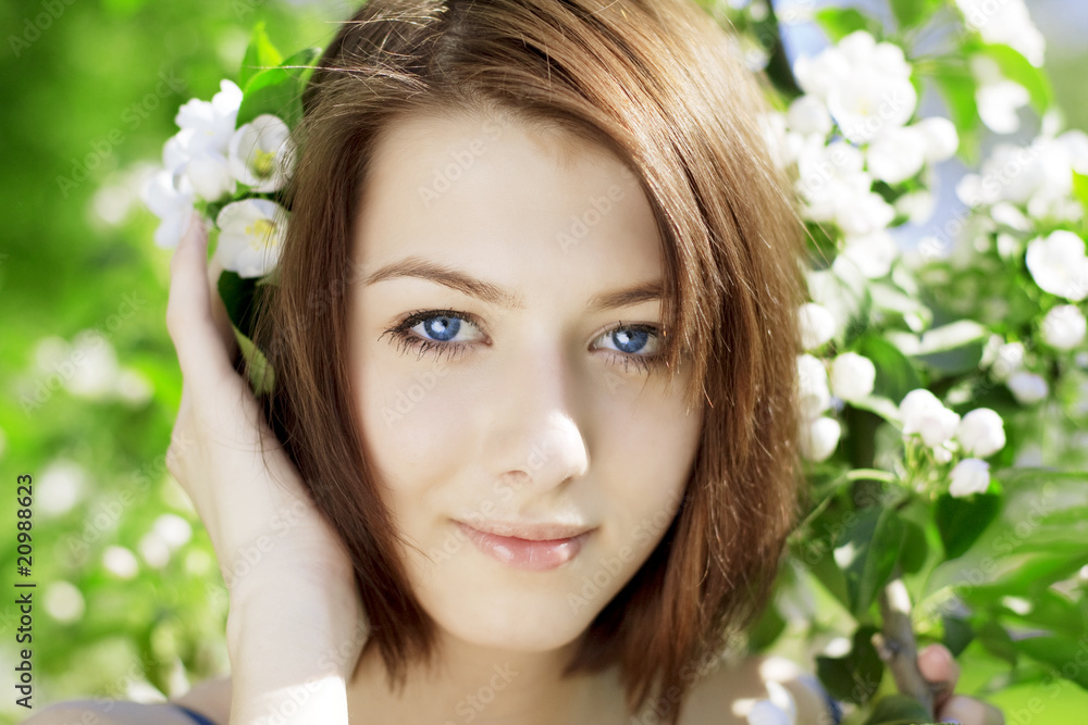 Girl on a background of flowering trees Girl on a background of flowering trees