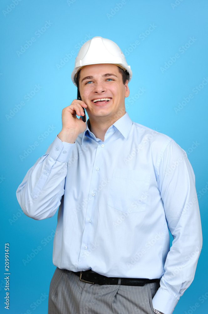 engineer with hard hat talking on his mobile phone engineer with hard hat talking on his mobile phone