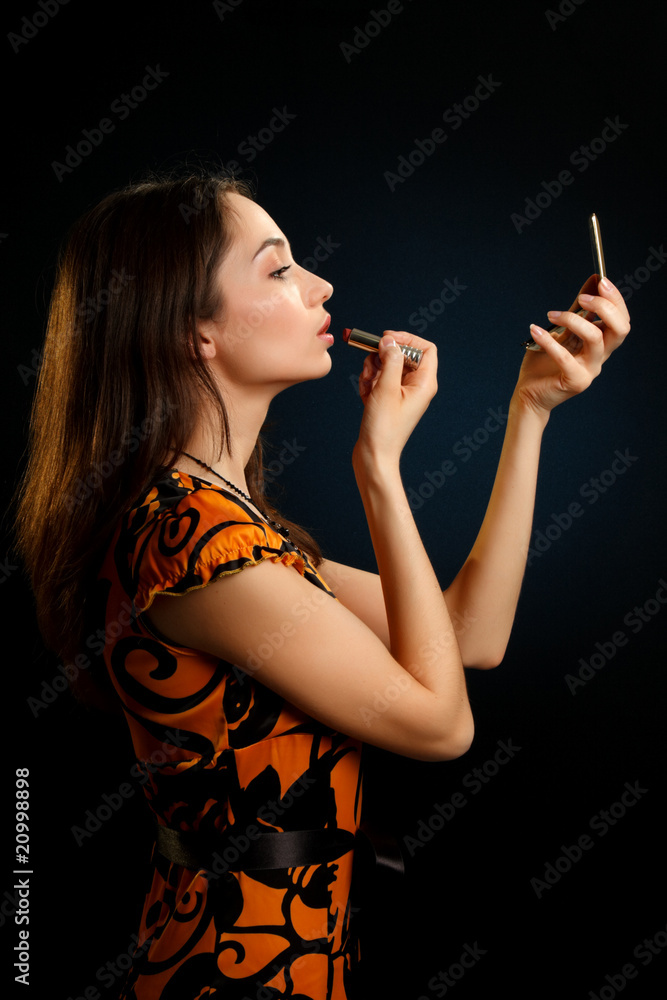 Fototapeta premium Pretty woman checking face skin looking at mirror