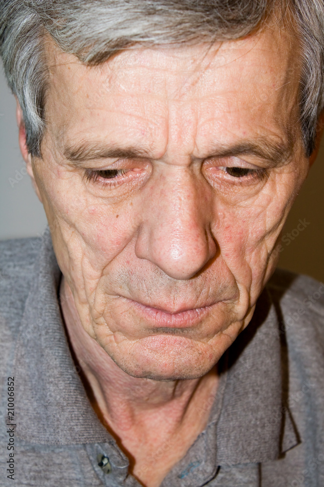 Closeup of a senior man looking away in deep thought Closeup of a senior man looking away in deep thought