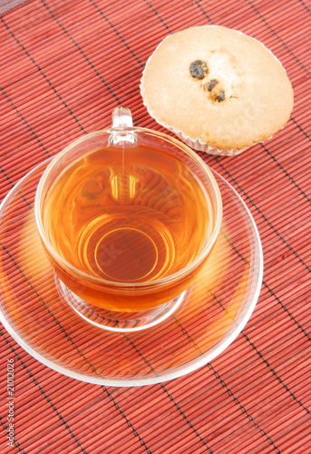 Cup of tea and fruitcake on bamboo background photo