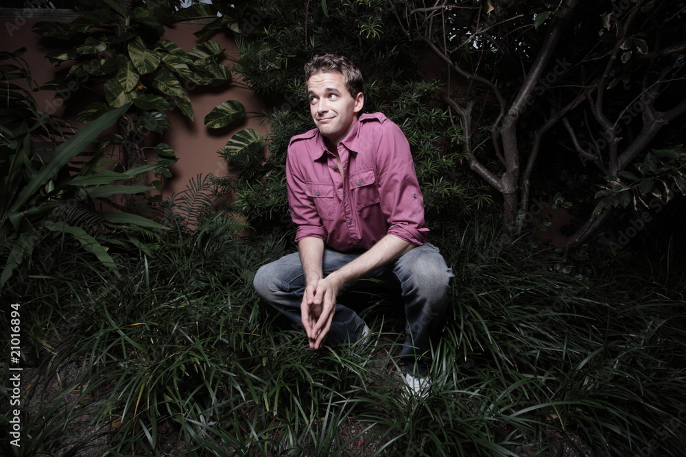 Man squatting in the bushes Man squatting in the bushes