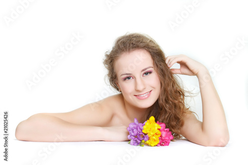 studio shot of beautiful young woman with flowers