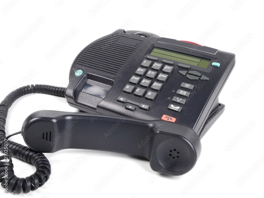 Handset laying aside of a desktop telephone Handset laying aside of a desktop telephone