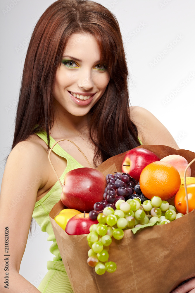 Smiling woman with fruits and vegetables. Over white Smiling woman with fruits and vegetables. Over white