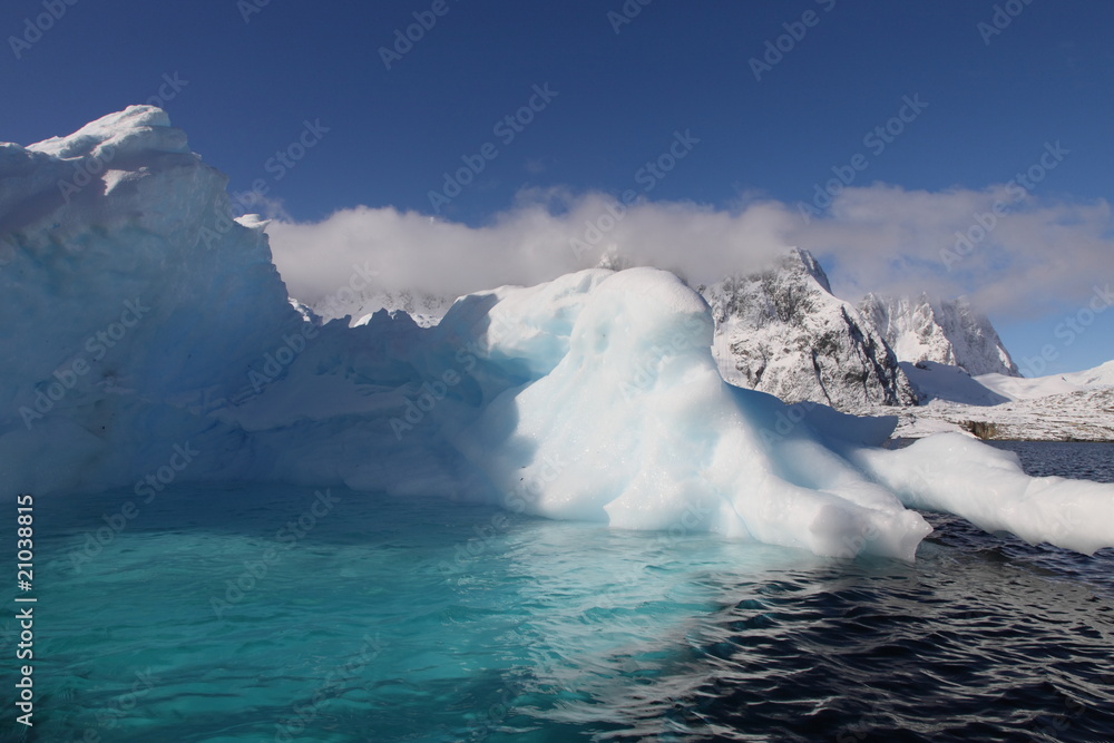 Iceberg with pool in Antarctica seen from a sailing boat