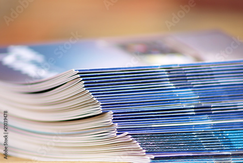 new magazines in pile over desk