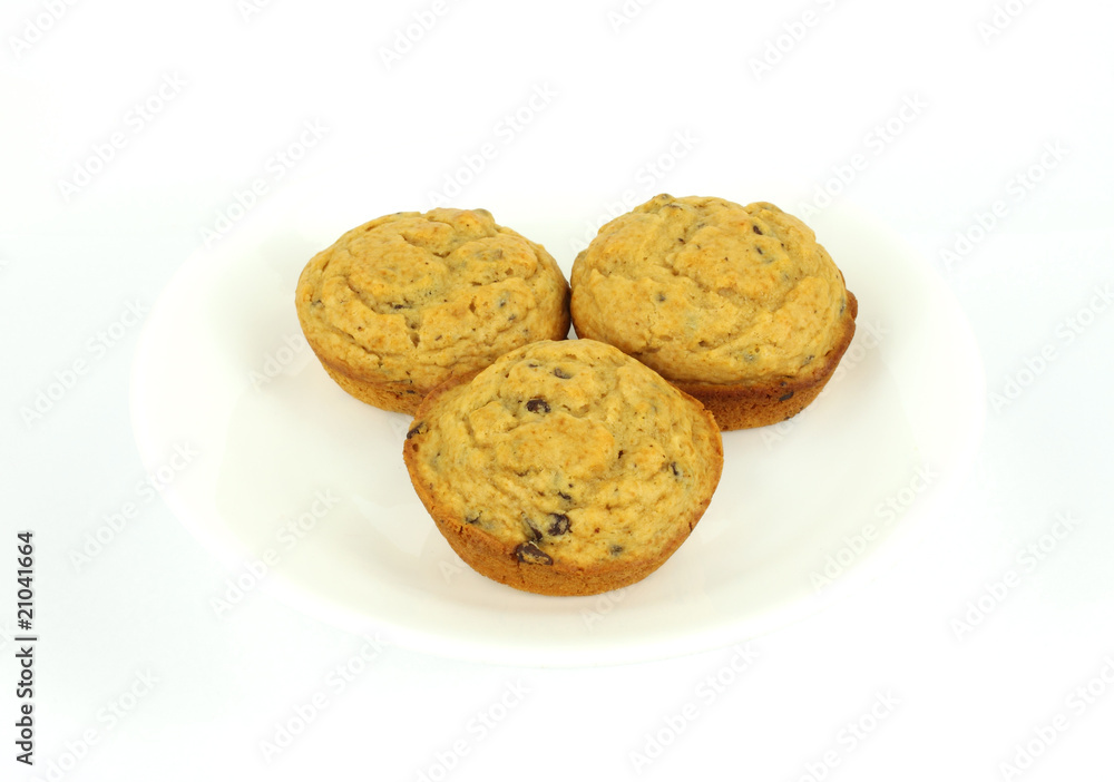 Three chocolate chip muffins on a white plate Three chocolate chip muffins on a white plate