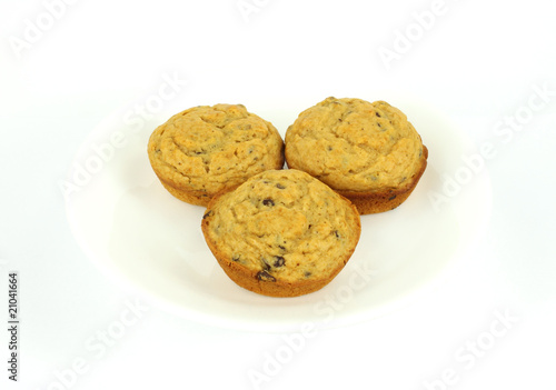 Three chocolate chip muffins on a white plate