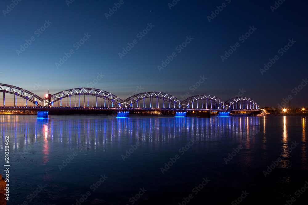 Blue railway bridge at night