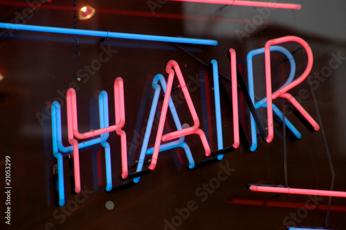 A neon sign in the window or a hair salon