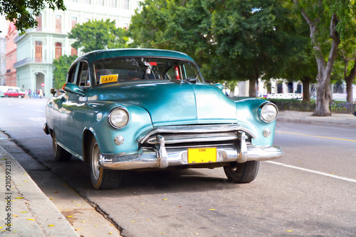 Metallic green oldtimer car in the streets of Havana