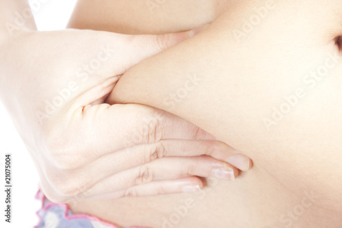 Woman pinching her fat tummy