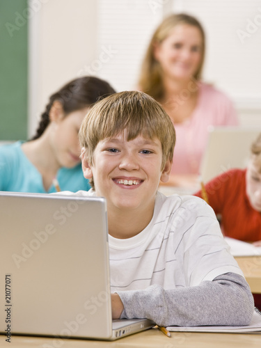 Student using laptop in classroom