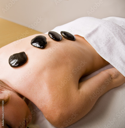 Woman receiving hot stone therapy massage