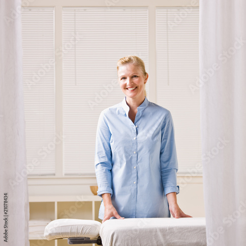 Massage therapist next to massage table