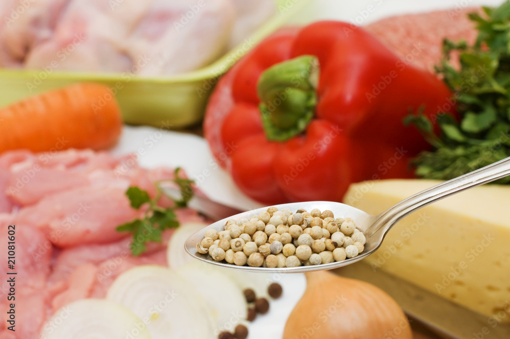Spices on a spoon against vegetables Spices on a spoon against vegetables