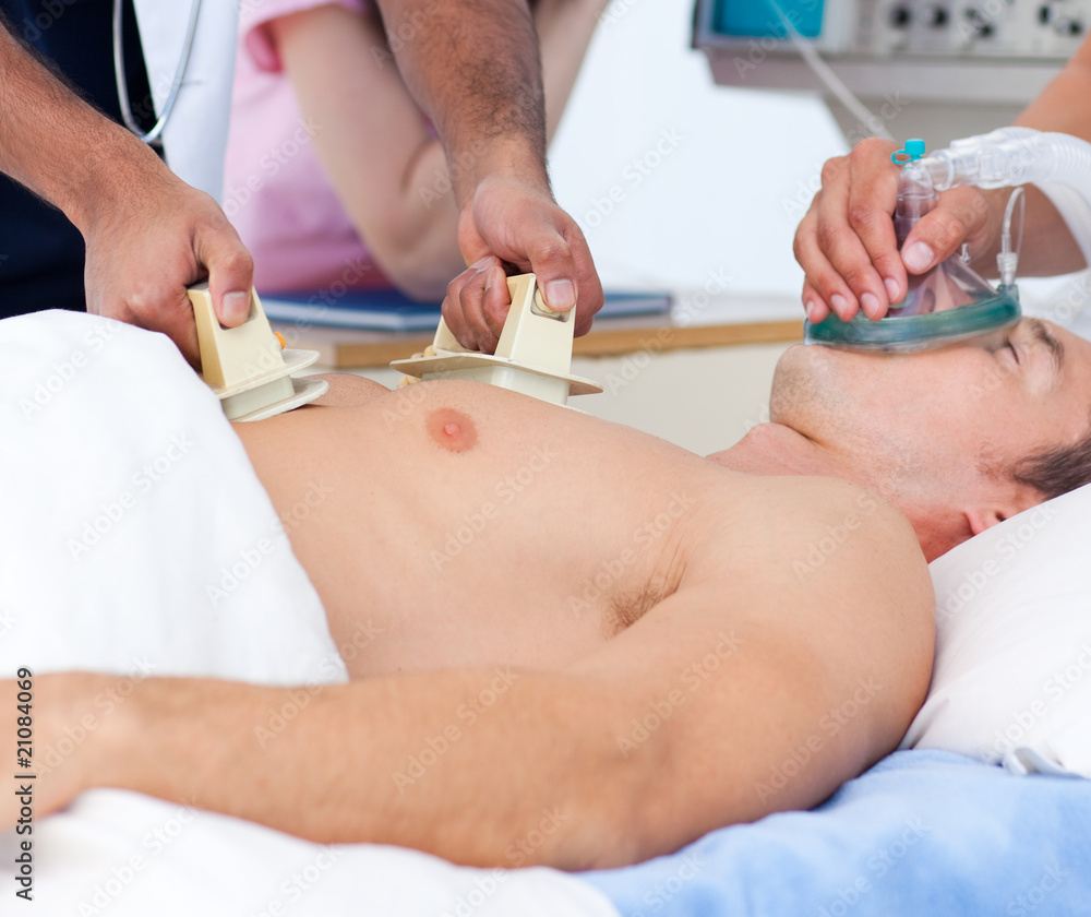 Close-up of a medical team resuscitating a patient Close-up of a medical team resuscitating a patient