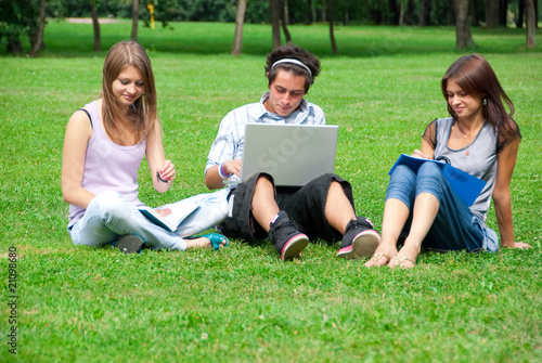 Three students studying outdoors