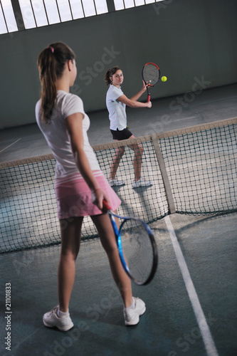 young girls playing tennis game indoor © .shock