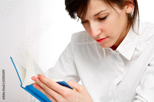 young woman reading a book with attention