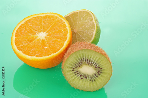 Fototapeta Naklejka Na Ścianę i Meble -  Orange and other fruits on green