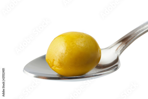 olive in spoon isolated on white