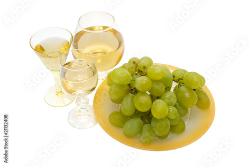 glasses of wine and a bunch of grapes on a white background