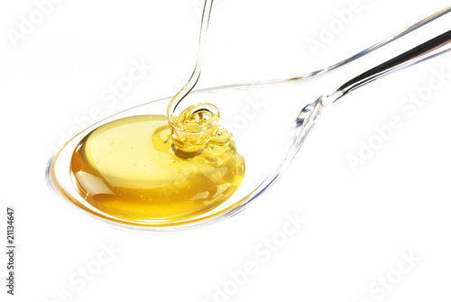 glass spoon with flowing honey