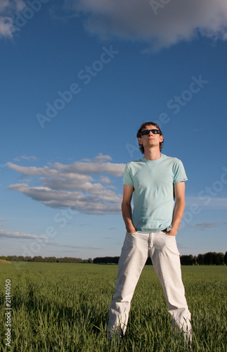Man in sunglasses looks up in the sky
